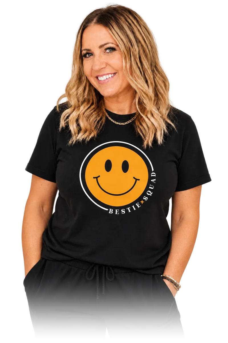 Dani, founder of the Bestie Squad, wearing a black Bestie Squad t-shirt with the yellow smiley logo.
