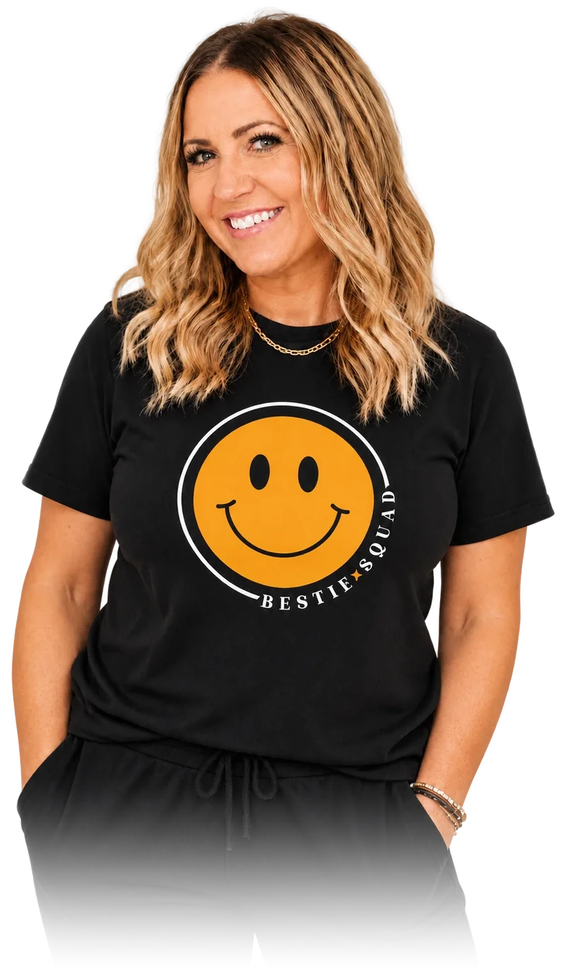 Dani, founder of the Bestie Squad, wearing a black Bestie Squad t-shirt with the yellow smiley logo.