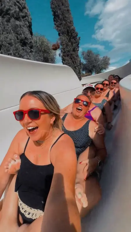 Bestie Squad members laughing together in a selfie at a water park.